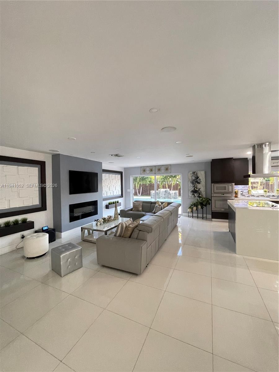 6901 Northwest 82nd Court Tamarac, FL 33321 - Photo 2 of 13 a living room with furniture and a flat screen tv