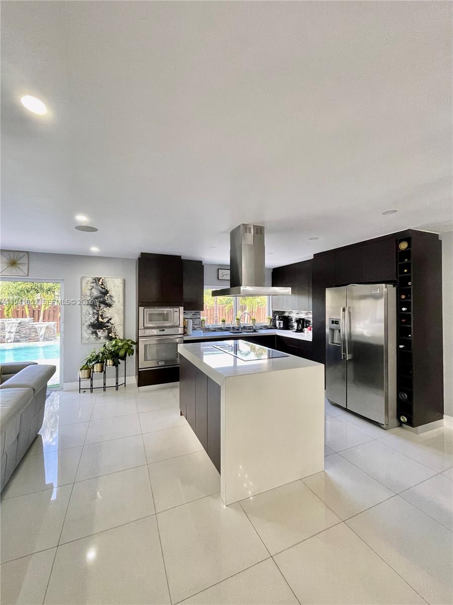 6901 Northwest 82nd Court Tamarac, FL 33321 - Photo 3 of 13 a kitchen with stainless steel appliances a stove a sink and a refrigerator