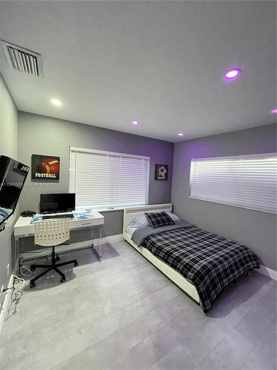 6901 Northwest 82nd Court Tamarac, FL 33321 - Photo 7 of 13 a living room with furniture rug and a window