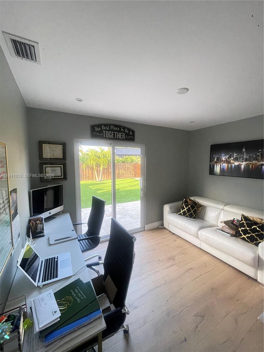 6901 Northwest 82nd Court Tamarac, FL 33321 - Photo 8 of 13 a living room with furniture and a window
