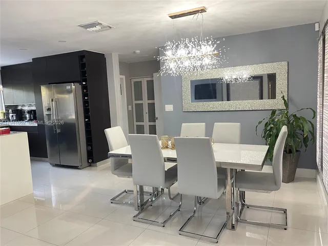 a view of a dining room with furniture and chandelier