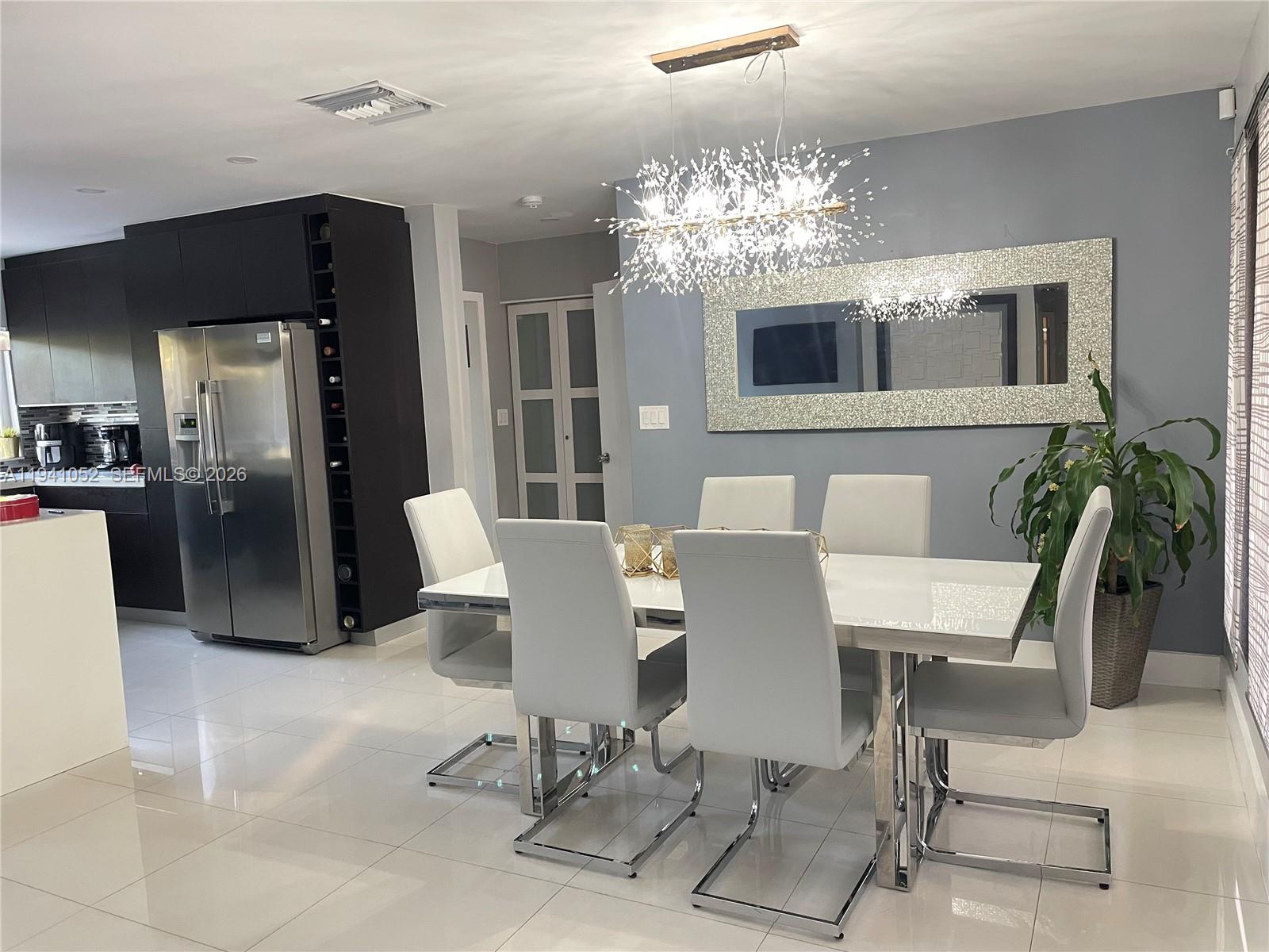 6901 Northwest 82nd Court Tamarac, FL 33321 - Photo 10 of 13 a view of a dining room with furniture and chandelier