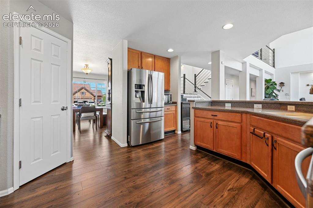 10643 Pictured Rocks Drive Peyton, CO 80831 - Photo 4 of 37 a kitchen with stainless steel appliances granite countertop a refrigerator a sink and white cabinets