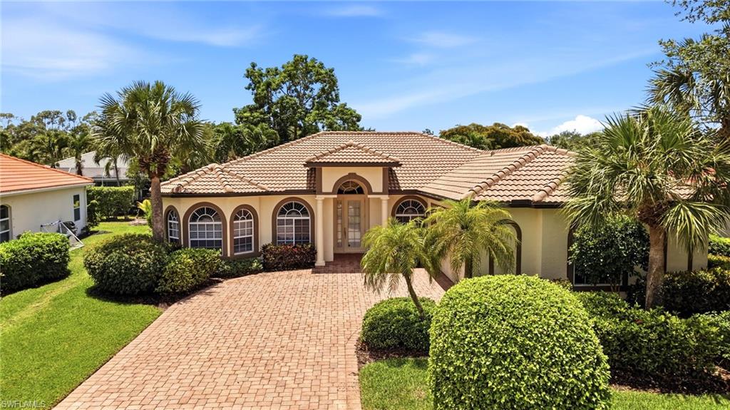 3951 Ruxton Road Naples, FL 34116 - Photo 1 of 35 a front view of a house with a yard