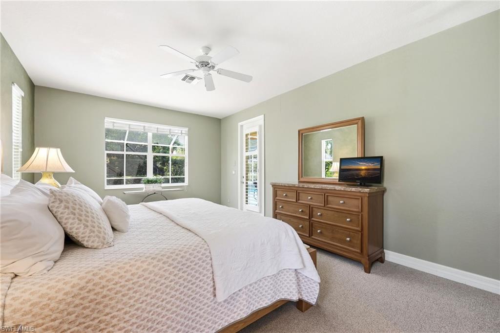 3951 Ruxton Road Naples, FL 34116 - Photo 15 of 35 a bedroom with a bed and wooden floor