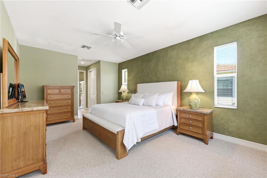3951 Ruxton Road Naples, FL 34116 - Photo 16 of 35 a bedroom with a bed dresser and a window