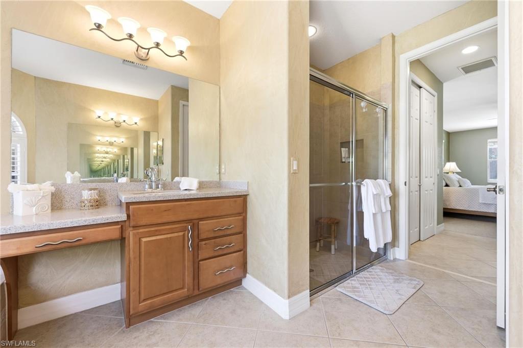 3951 Ruxton Road Naples, FL 34116 - Photo 18 of 35 a bathroom with a double vanity sink and a mirror