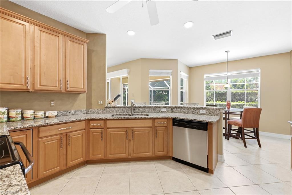 3951 Ruxton Road Naples, FL 34116 - Photo 22 of 35 a kitchen with a sink and chairs