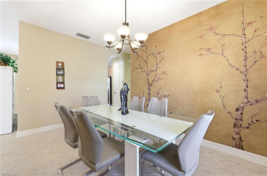 3951 Ruxton Road Naples, FL 34116 - Photo 24 of 35 a view of a dining room with furniture and wooden floor