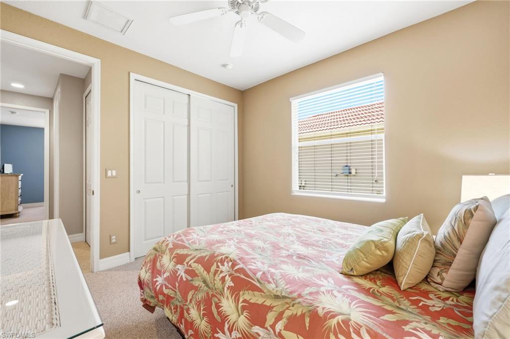 3951 Ruxton Road Naples, FL 34116 - Photo 25 of 35 a bedroom with a bed and a chandelier