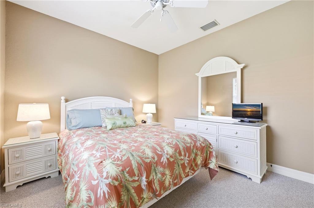 3951 Ruxton Road Naples, FL 34116 - Photo 26 of 35 a bedroom with a bed and a dresser