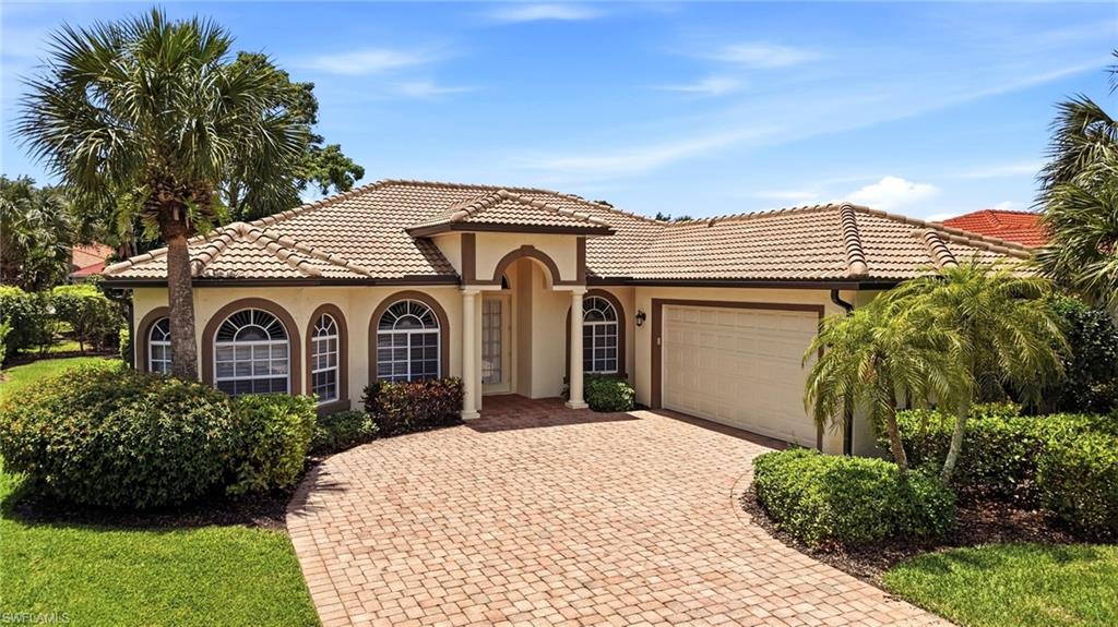 3951 Ruxton Road Naples, FL 34116 - Photo 31 of 35 a front view of a house with a yard