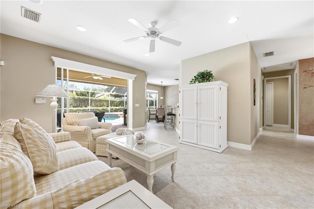 3951 Ruxton Road Naples, FL 34116 - Photo 9 of 35 a living room with furniture and a large window