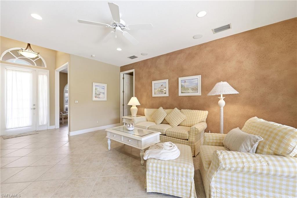 3951 Ruxton Road Naples, FL 34116 - Photo 10 of 35 a living room with furniture and a lamp