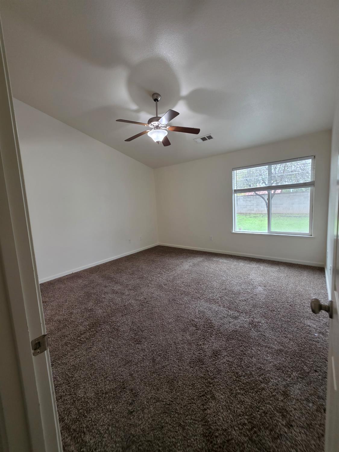 804 Morris Lane Madera, CA 93637 - Photo 11 of 17 wooden floor in an empty room with a window