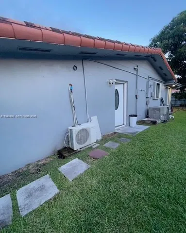 a backyard of a house with table and chairs