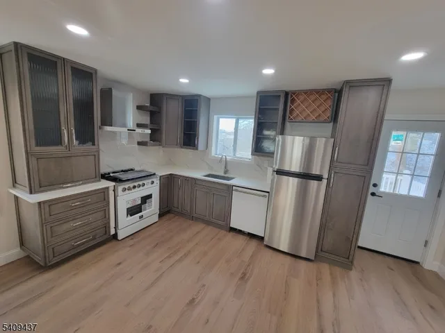a white toilet sitting next to a bathroom sink and vanity