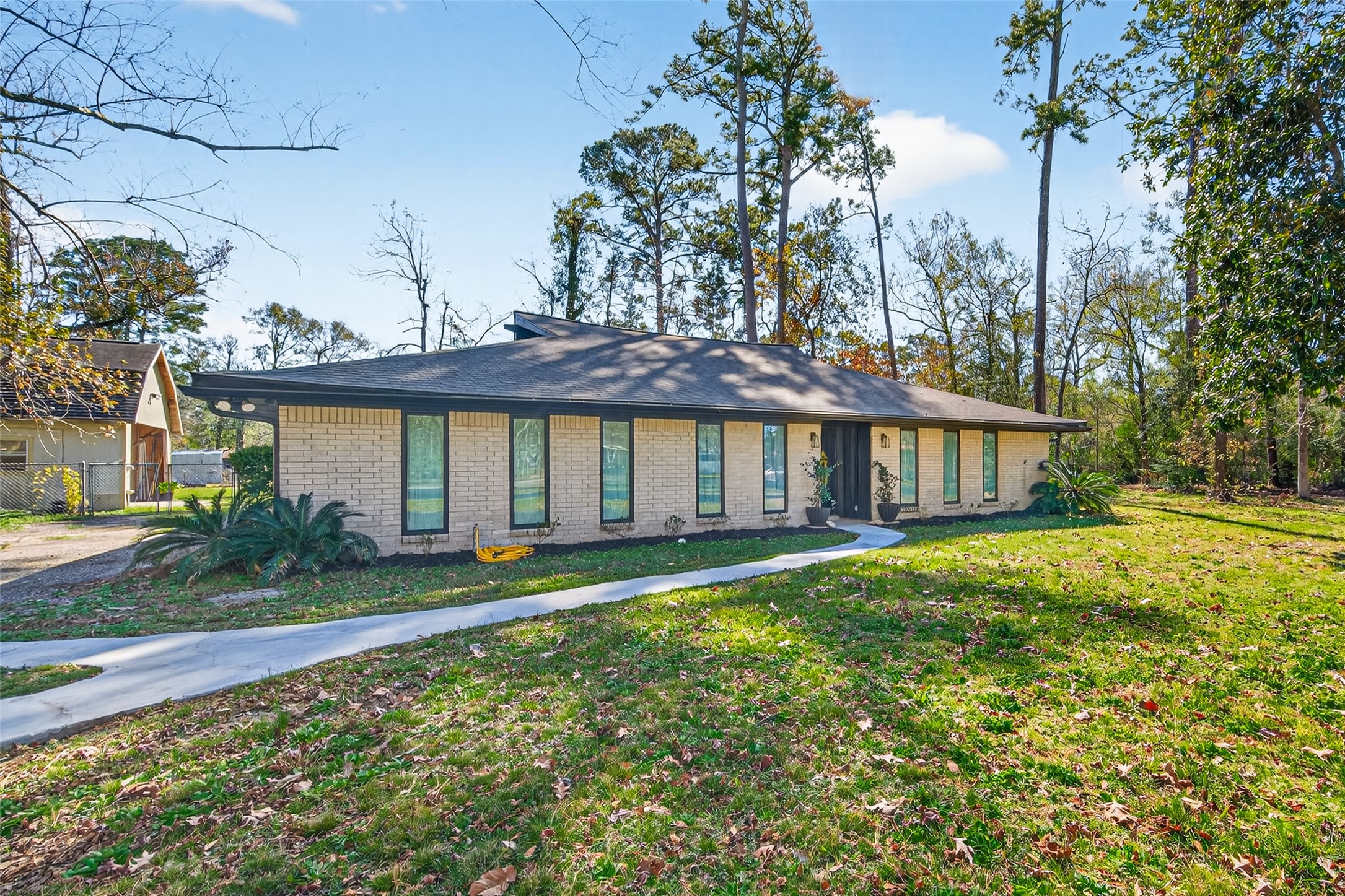 Charming single-story brick home nestled on a spacious, 1.2-acre, tree-lined cul-de-sac lot. Features a 2025 architectural shingle roof, oversized driveway, and lush landscaping with mature trees providing natural privacy and shade.