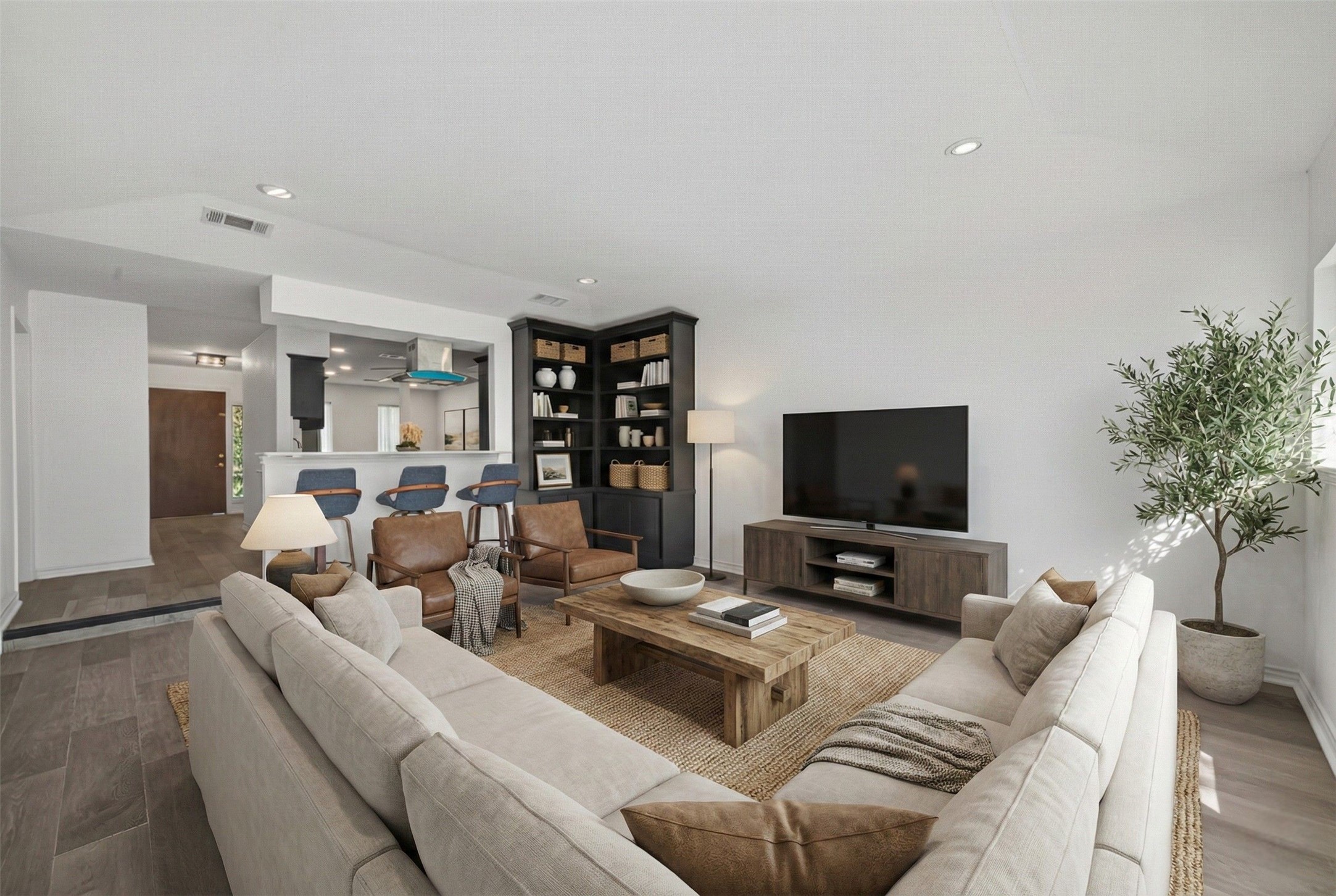 15335 Robin Trail Conroe, TX 77302 - Photo 13 of 38 Virtually staged spacious open-concept living area with abundant natural light. The expansive layout offers excellent flow from the kitchen and dining spaces, with generous room for multiple seating arrangements. Recessed lighting throughout and large windows create a bright, welcoming atmosphere perfect for relaxing and entertaining.