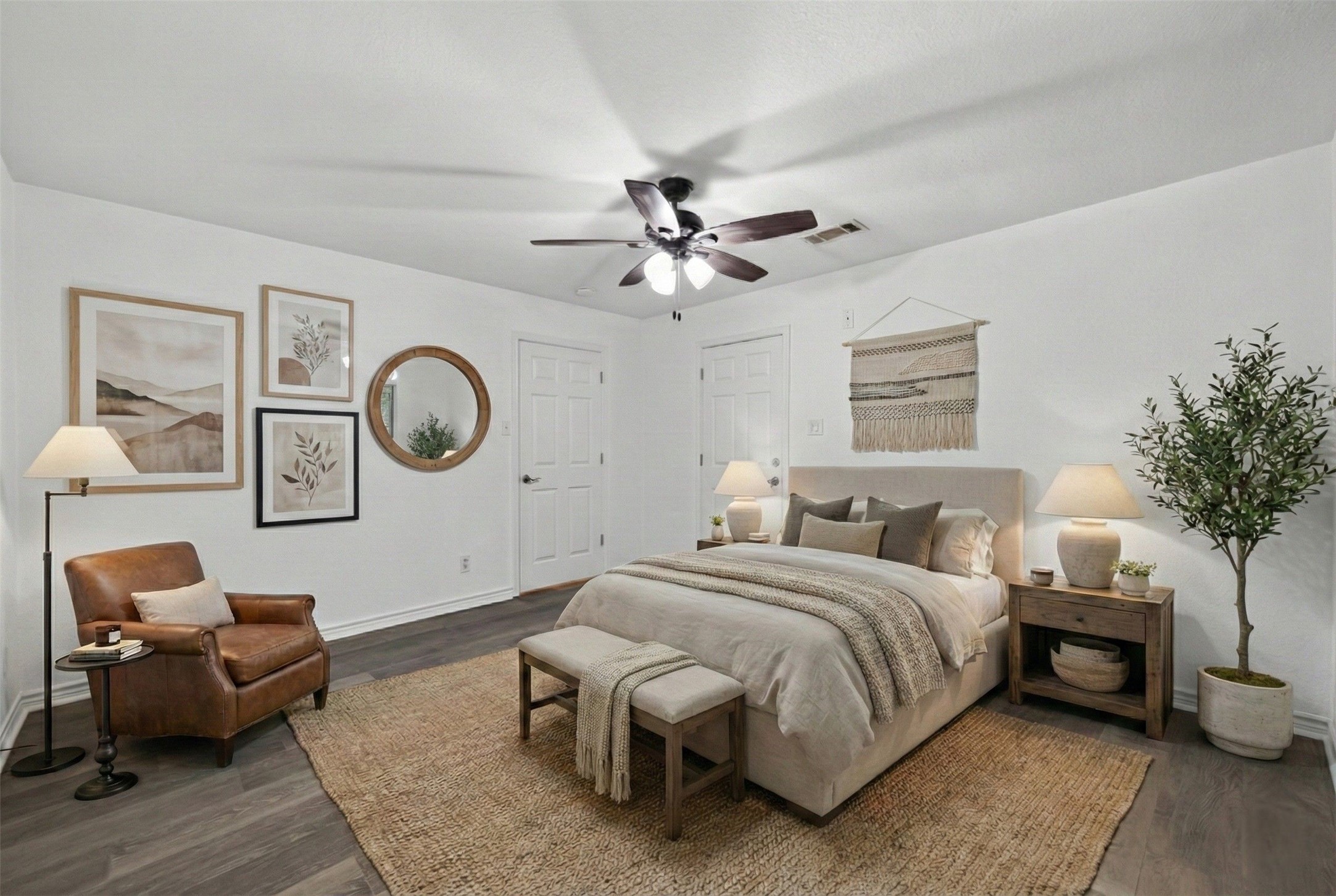 15335 Robin Trail Conroe, TX 77302 - Photo 19 of 38 Well-proportioned, virtually staged primary bedroom with ceiling fan and wall-to-wall wood-look tile. The room offers excellent natural light and space for a full bedroom suite.