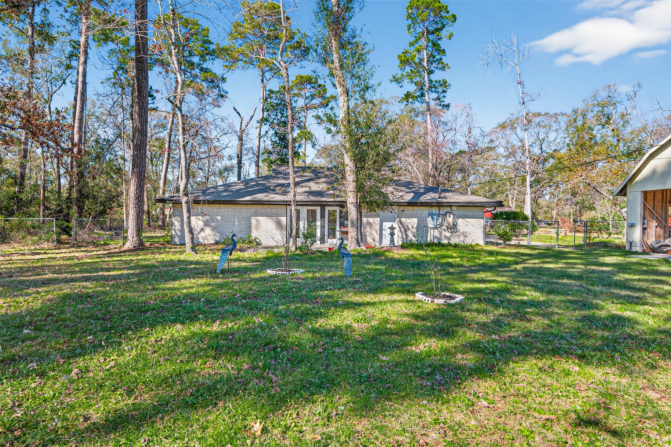 15335 Robin Trail Conroe, TX 77302 - Photo 4 of 38 Expansive 1.2-acre lot on a peaceful cul-de-sac, offering incredible space and privacy surrounded by mature trees. The huge backyard provides endless possibilities for outdoor activities, gardening, pool installation, or simply enjoying nature. This rare, oversized property combines the tranquility of country living with convenient access to area amenities, perfect for indoor and outdoor enthusiasts.