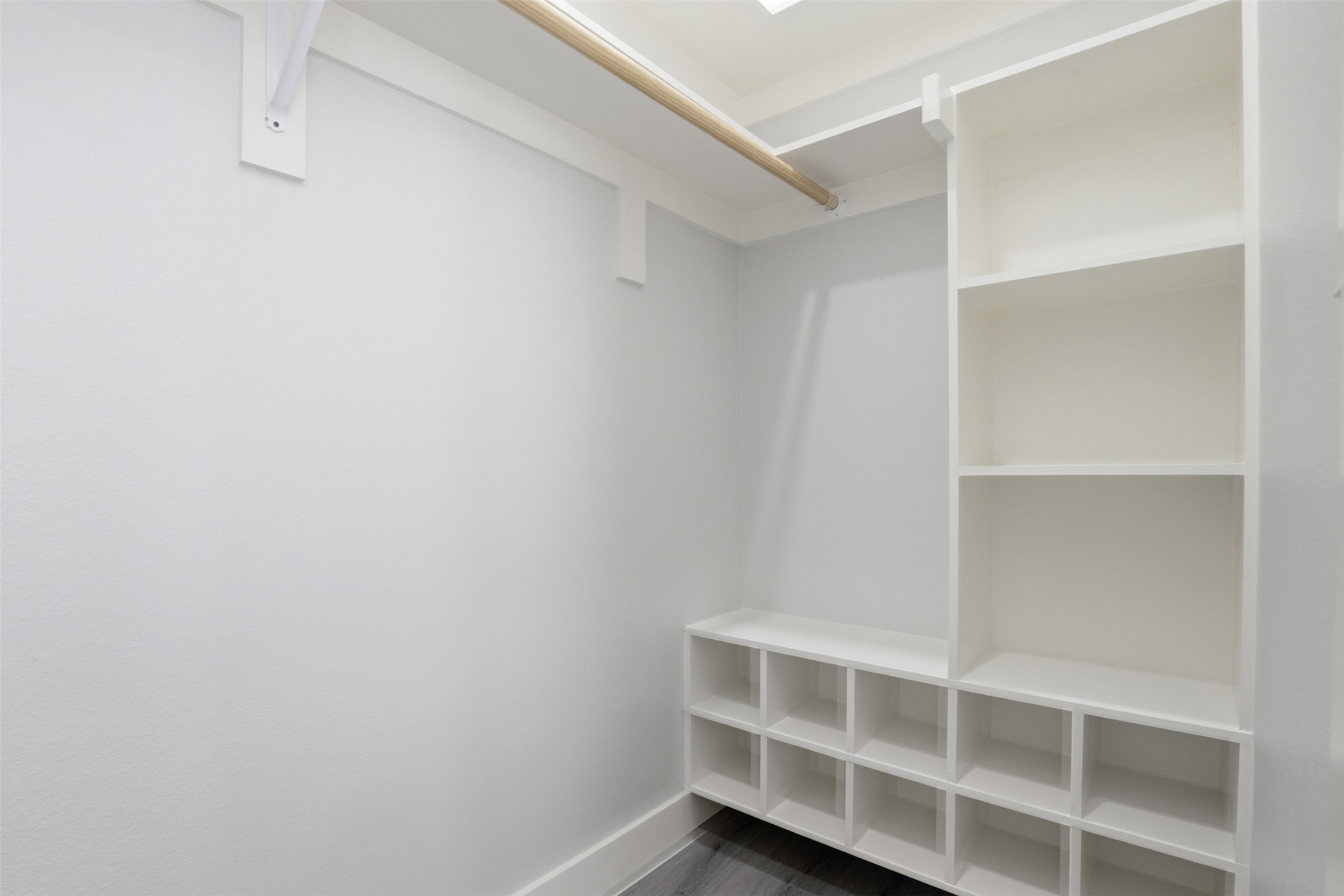 123 Los Robles Road Elgin, TX 78621 - Photo 14 of 21 Built-in white storage system featuring open shelving, multiple cubbies, and a hanging rod