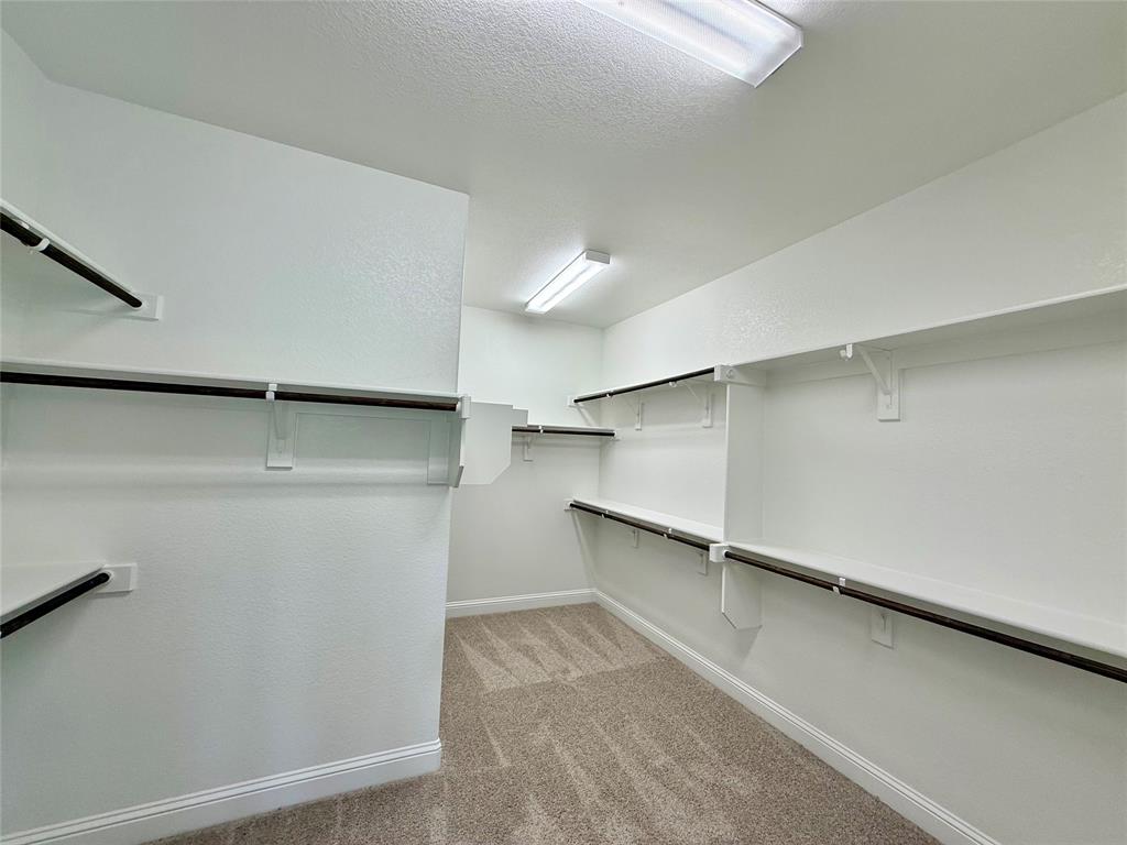 5004 Picasso Road Royse City, TX 75189 - Photo 11 of 20 a view of walk in closet with empty racks