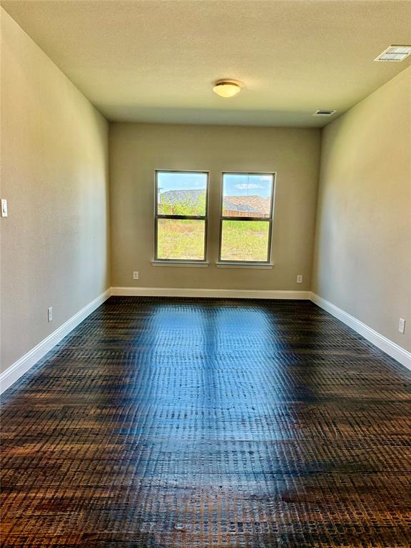 5004 Picasso Road Royse City, TX 75189 - Photo 3 of 20 an empty room with wooden floor and windows