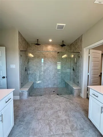 a bathroom with a glass shower sink and toilet