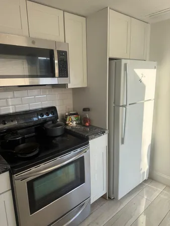 a kitchen with stainless steel appliances a stove a microwave and cabinets