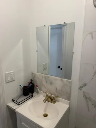 a bathroom with a sink and a mirror