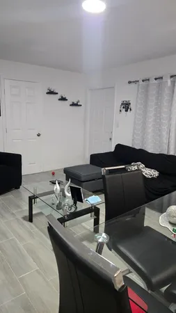 a table room with a couch and a stove top oven