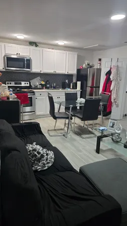 a living room with lots of furniture and kitchen view