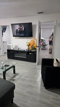 a living room with furniture and a flat screen tv