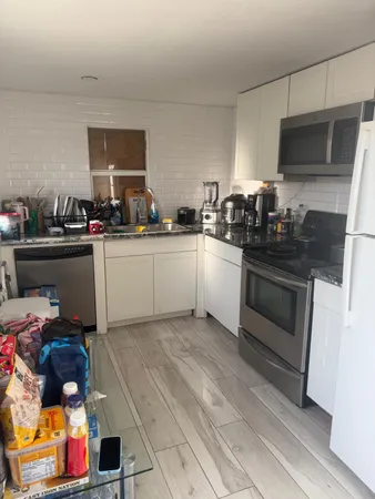a kitchen with a sink stove and cabinets