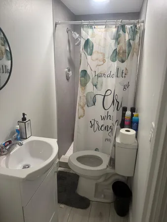 a white toilet sitting next to a bathroom sink