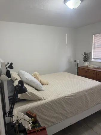a bedroom with a bed and a chair