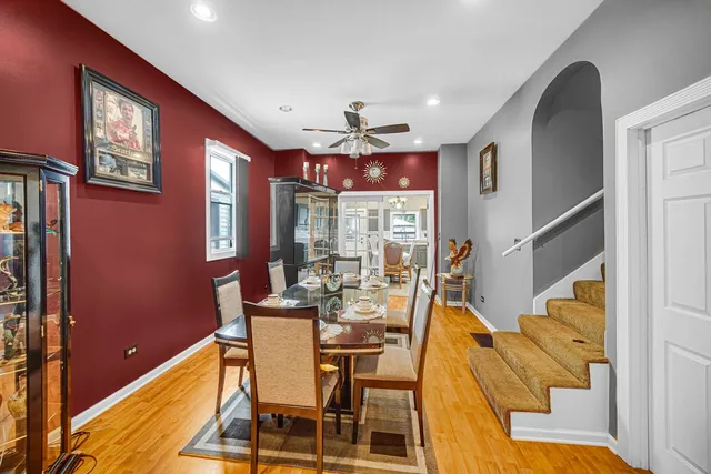 a dining room with furniture a chandelier and window