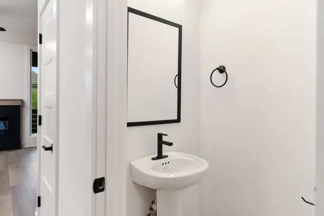 a bathroom with a sink a mirror and shower