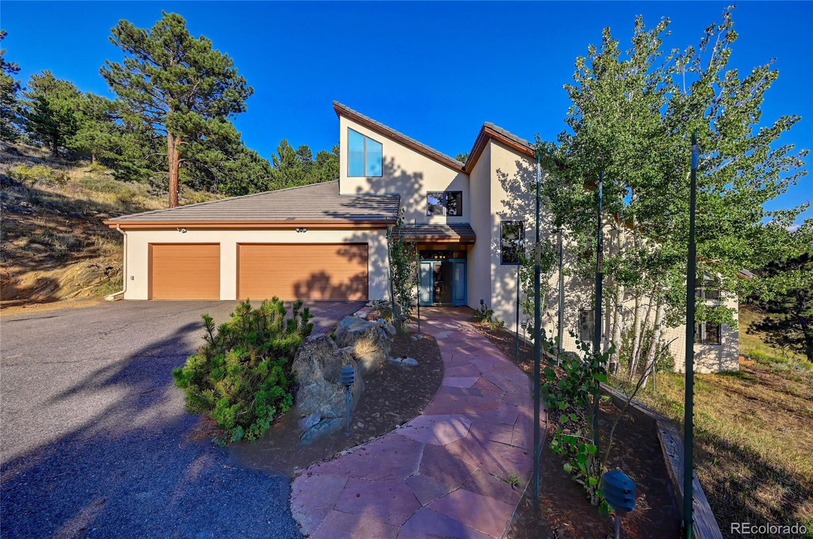 a front view of a house with garden