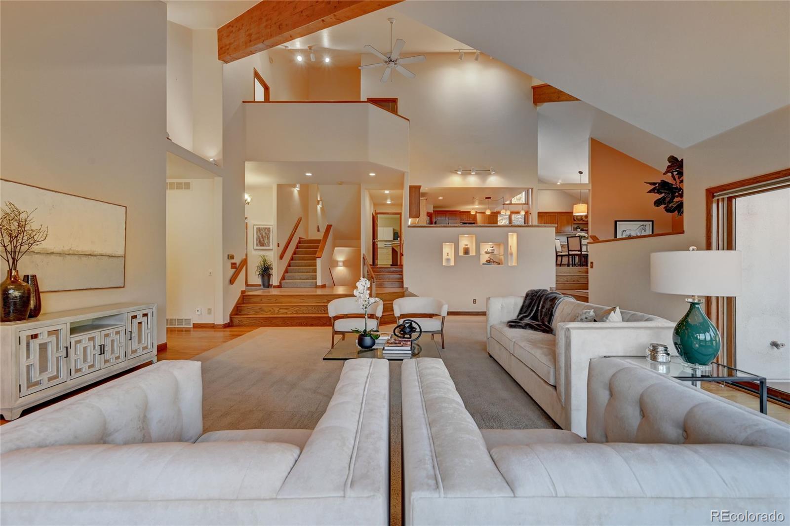 734 Spring Ranch Drive Golden, CO 80401 - Photo 11 of 40 a living room with furniture and a chandelier