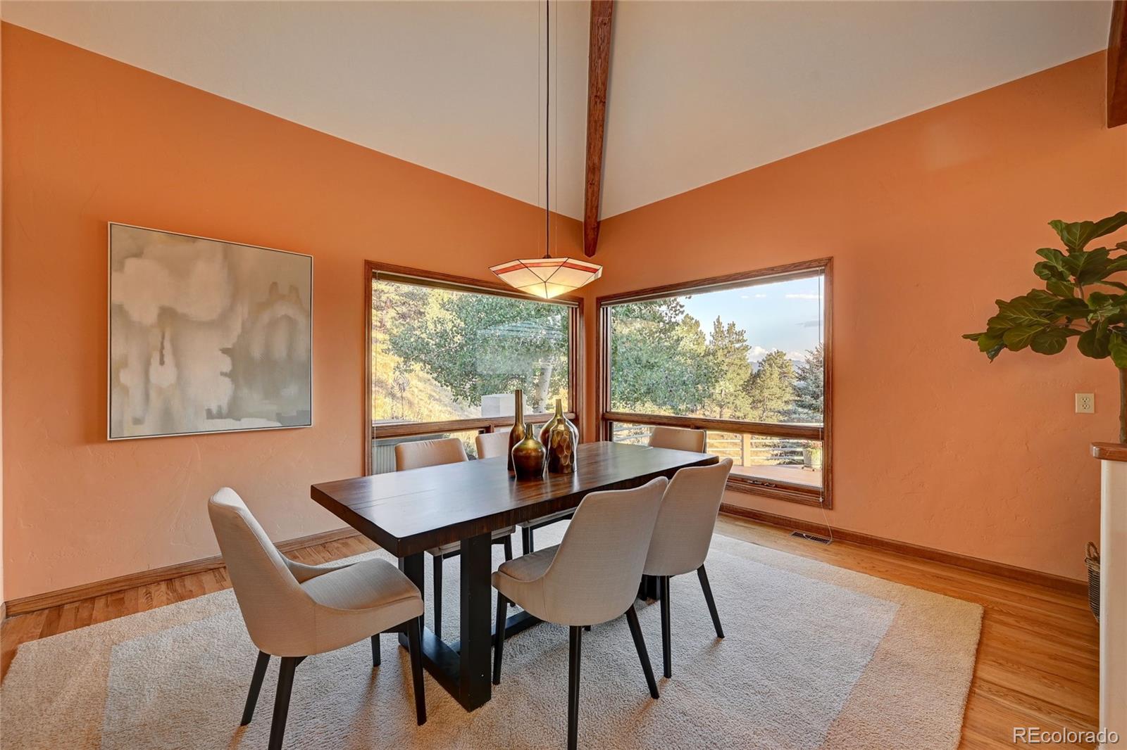 734 Spring Ranch Drive Golden, CO 80401 - Photo 12 of 40 a dining room with furniture a rug and wooden floor