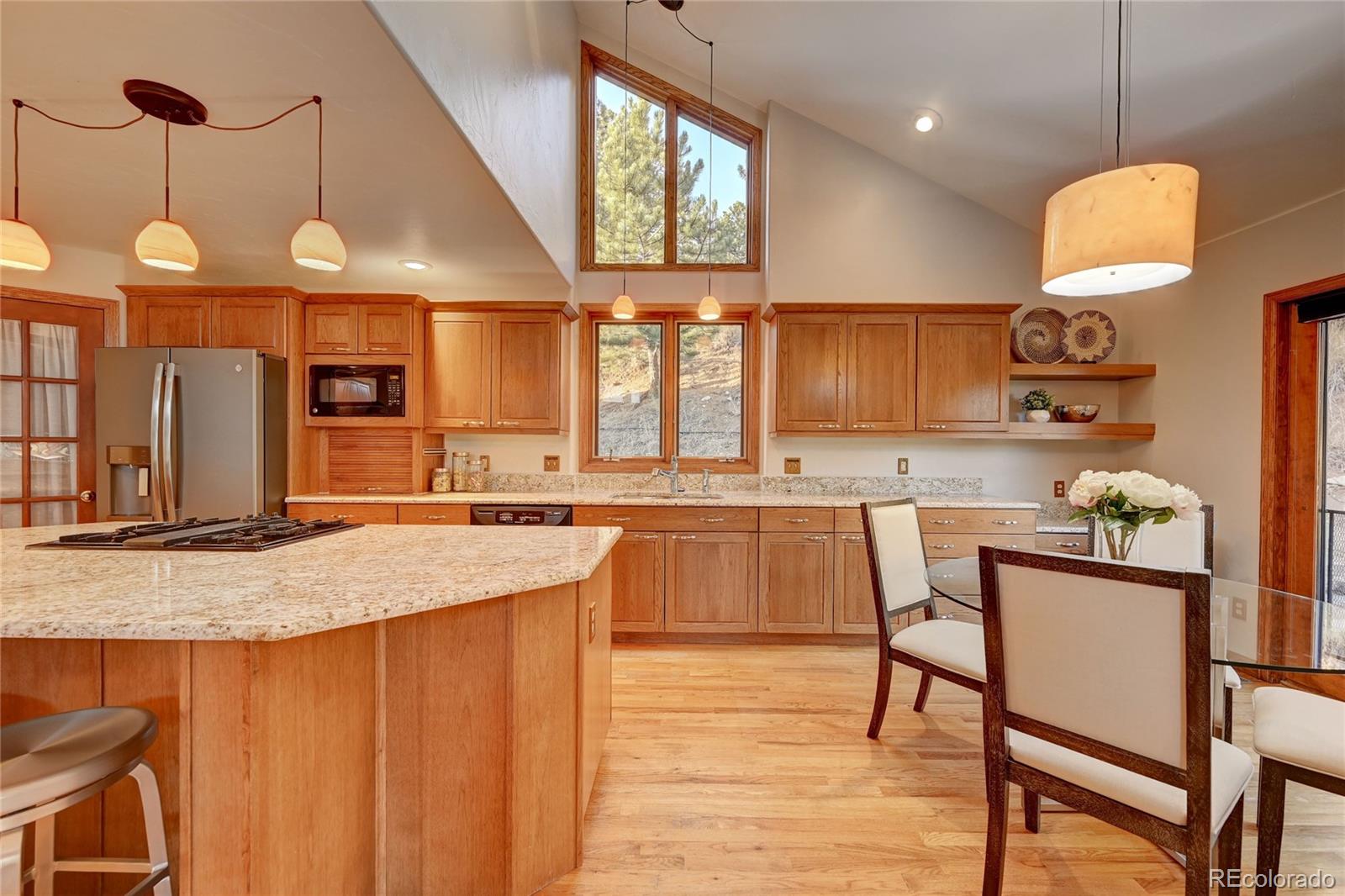 734 Spring Ranch Drive Golden, CO 80401 - Photo 13 of 40 a kitchen with stainless steel appliances granite countertop a sink a stove and a wooden floors