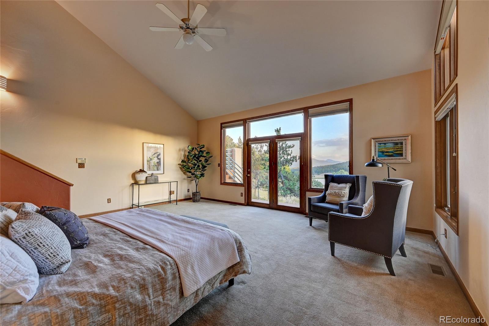734 Spring Ranch Drive Golden, CO 80401 - Photo 19 of 40 a spacious bedroom with a bed and a couch