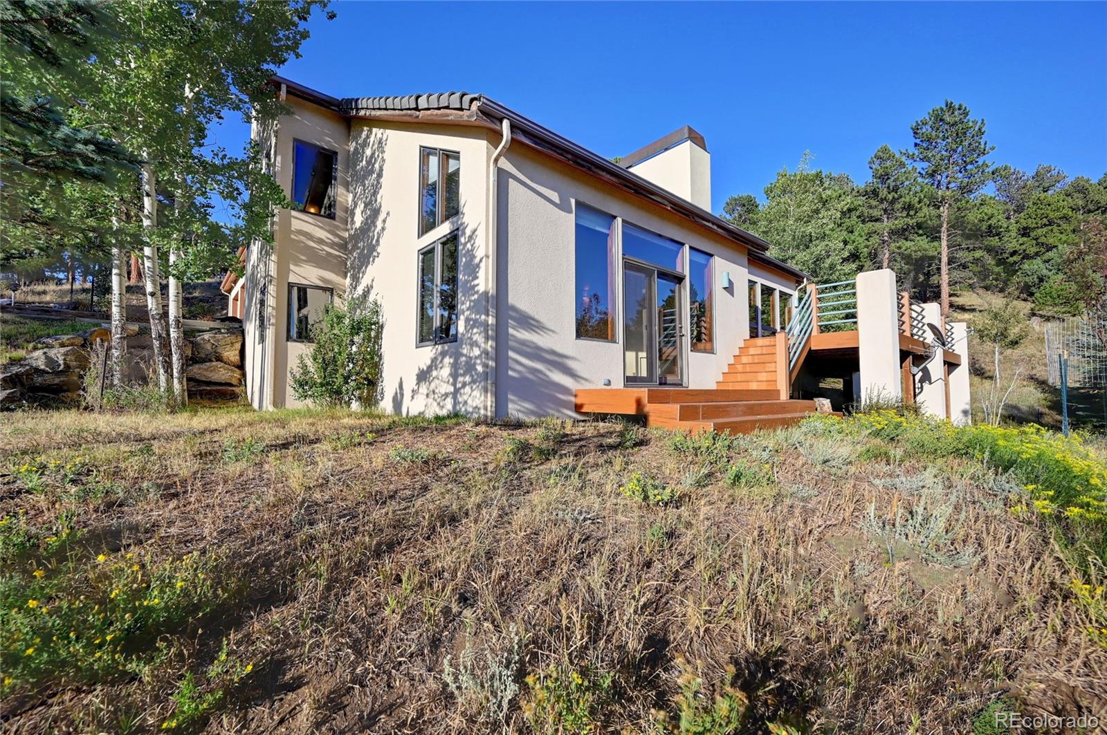 734 Spring Ranch Drive Golden, CO 80401 - Photo 2 of 40 a front view of a house with a yard