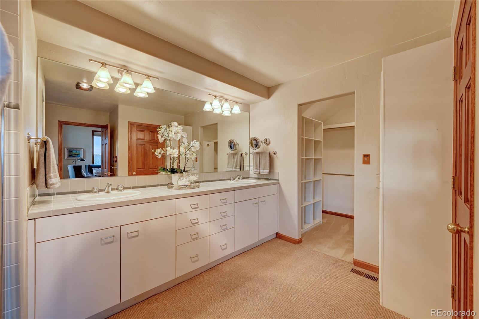 734 Spring Ranch Drive Golden, CO 80401 - Photo 21 of 40 a spacious bathroom with a double vanity sink and a mirror