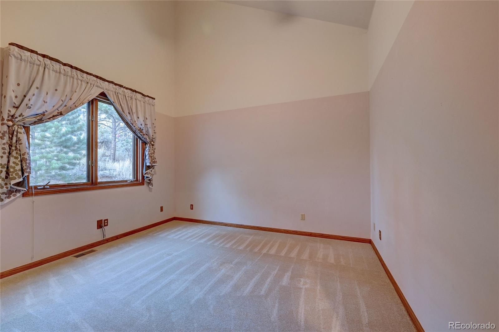 734 Spring Ranch Drive Golden, CO 80401 - Photo 25 of 40 a view of an empty room with wooden floor and windows