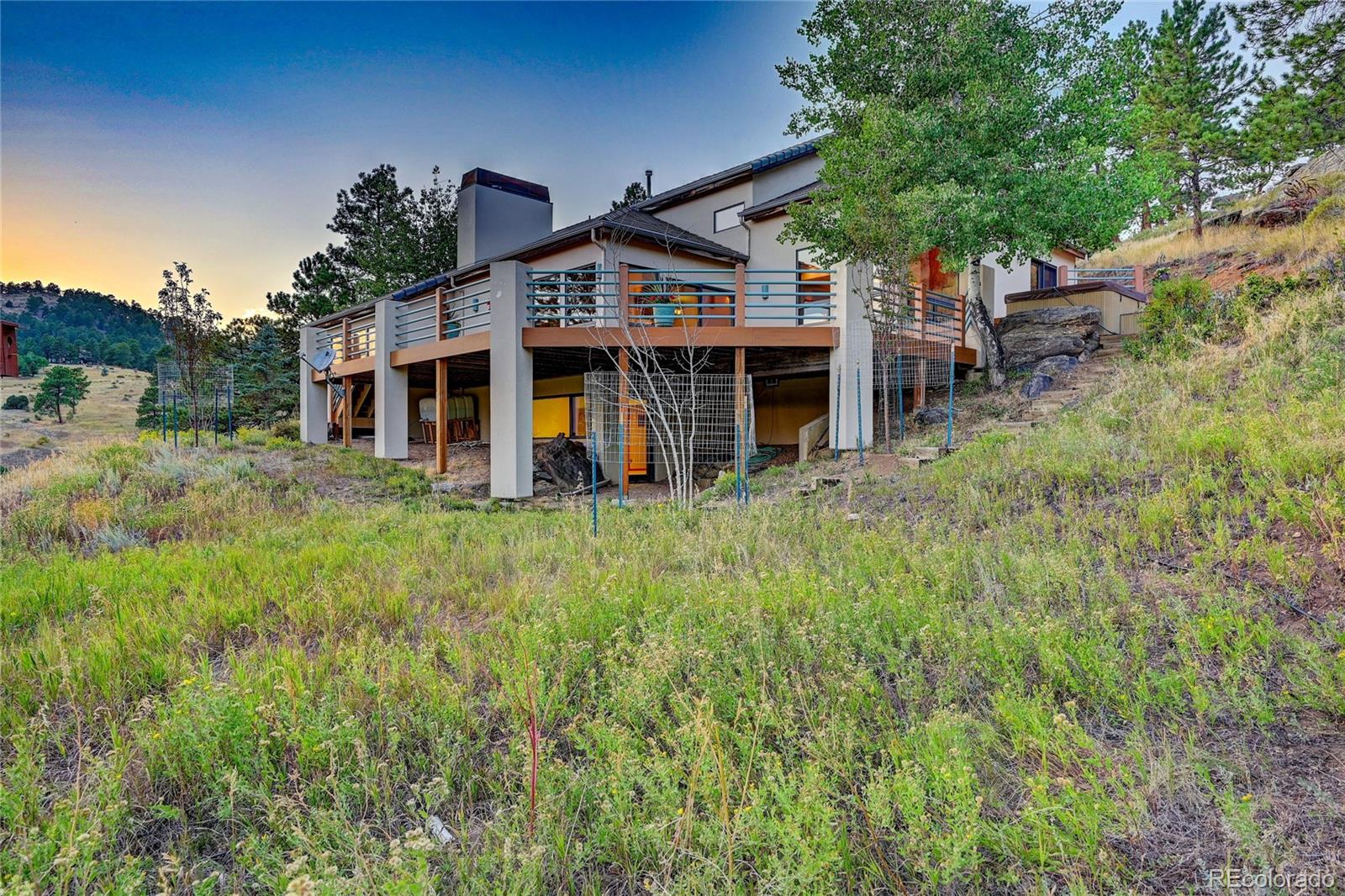 734 Spring Ranch Drive Golden, CO 80401 - Photo 31 of 40 a view of a house with a big yard and large trees
