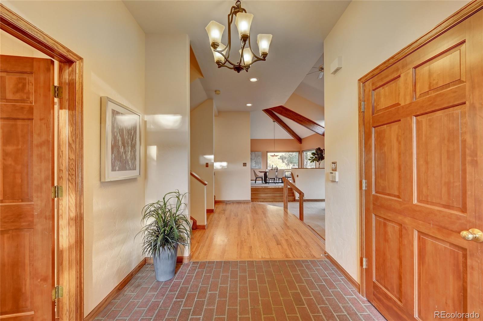 734 Spring Ranch Drive Golden, CO 80401 - Photo 6 of 40 a view of a hallway with wooden floor and staircase