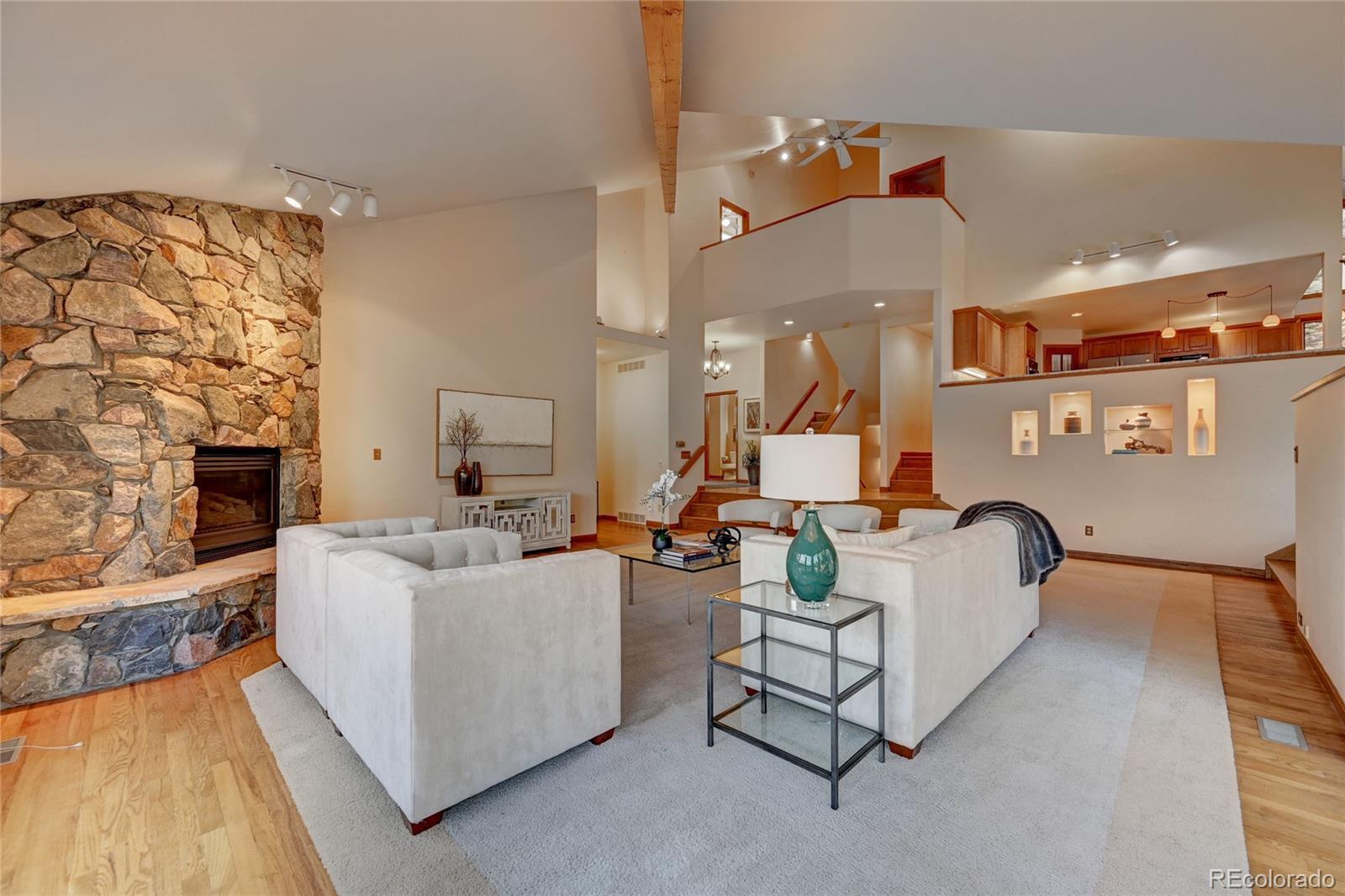 734 Spring Ranch Drive Golden, CO 80401 - Photo 10 of 40 a living room with furniture and a fireplace